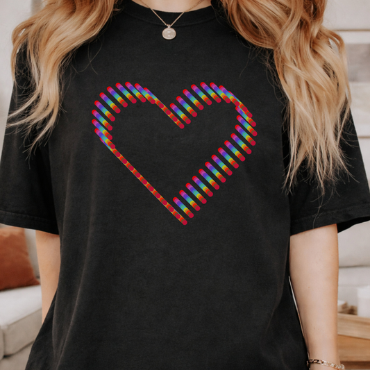 black comfort colors t-shirt with a colorful rainbow heart design. 