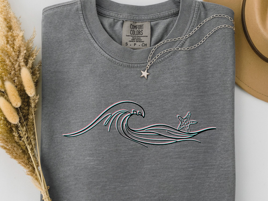 Grey comfort colors t-shirt with wave and starfish design. 