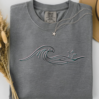 Grey comfort colors t-shirt with wave and starfish design. 