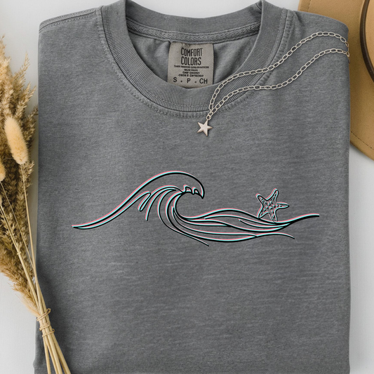 Grey comfort colors t-shirt with wave and starfish design. 