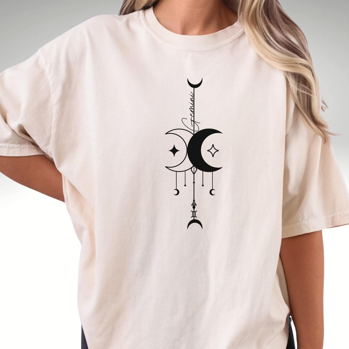beige comfort colors t-shirt with a black celestial design and 'Gemini' text. 