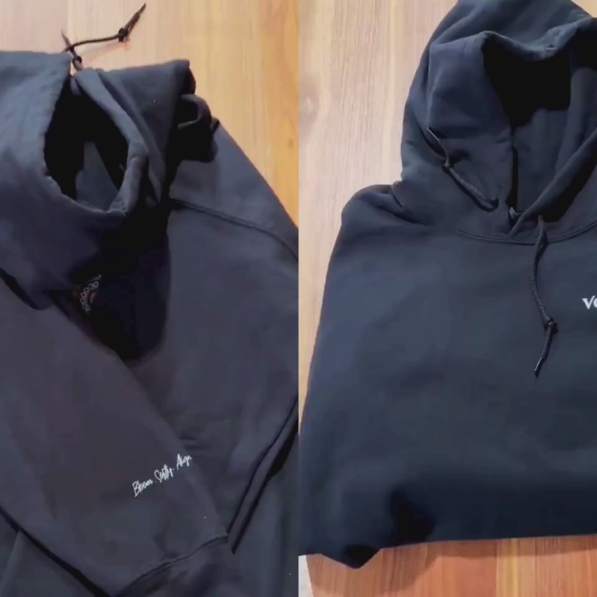 Black hoodie with a colorful rainbow floral mandala pattern on the back and a minimalist logo 'Vogart' on th front video. 
