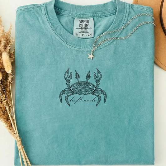 seafoam comfort colors t-shirt with a crab line art design alone with a minimalist 'drift mode' text. 